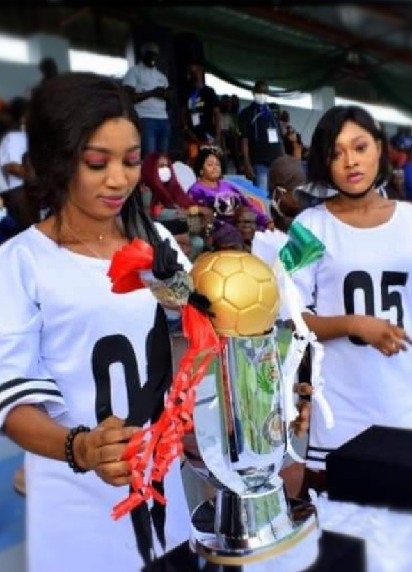 A man holding a trophy.